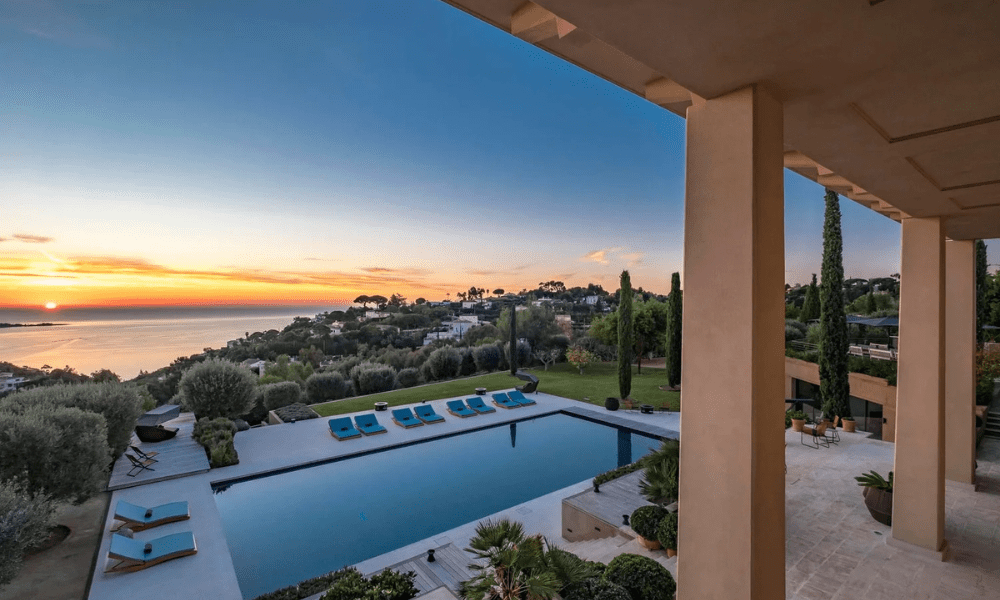 Wide-angle exterior shot capturing villa façade and surrounding greenery